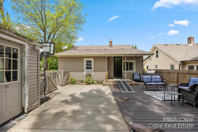 772 26th St SW, Wyoming, MI 49509 - back of property with outdoor lounge area, a deck, a chimney, and a gate