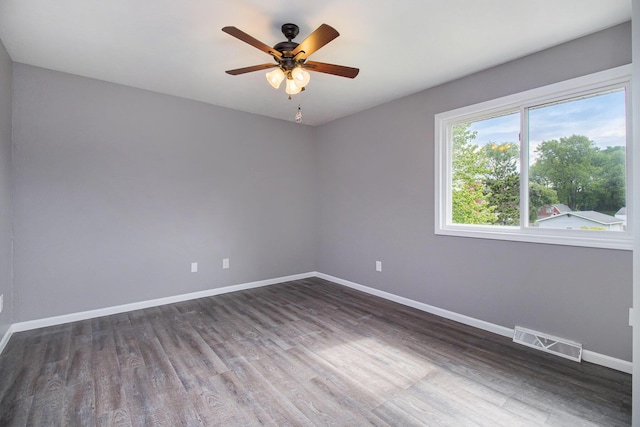 4273 20th St, Dorr, MI 49323 - empty room featuring dark wood-type flooring, baseboards, and a ceiling fan
