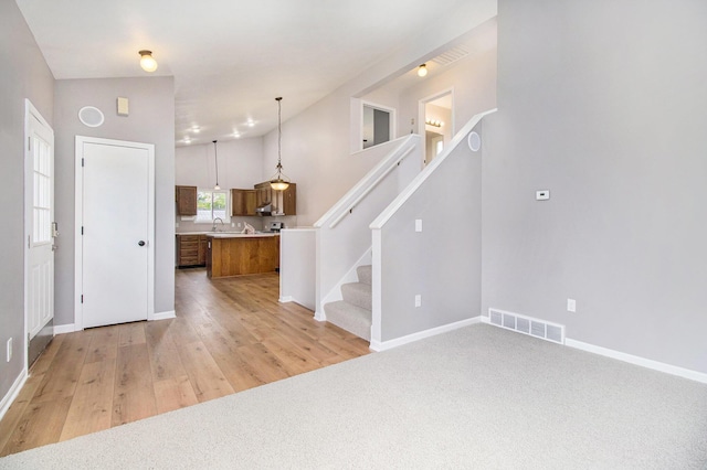 4273 20th St, Dorr, MI 49323 - entryway featuring baseboards, light wood-type flooring, and stairway