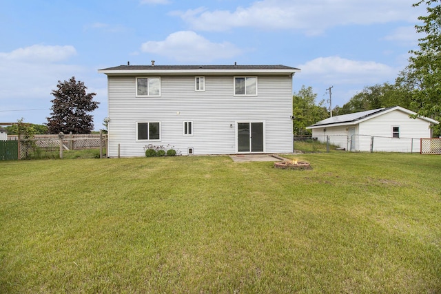 4273 20th St, Dorr, MI 49323 - rear view of house with a fire pit