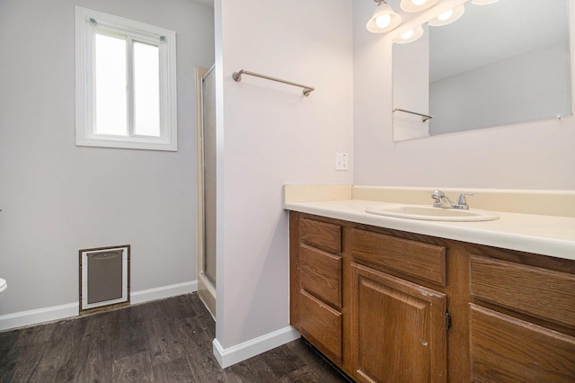 4273 20th St, Dorr, MI 49323 - bathroom featuring vanity, a shower stall, wood finished floors, and baseboards