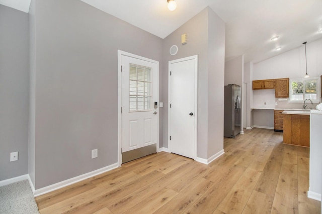 4273 20th St, Dorr, MI 49323 - entryway with lofted ceiling, light wood-style flooring, and baseboards