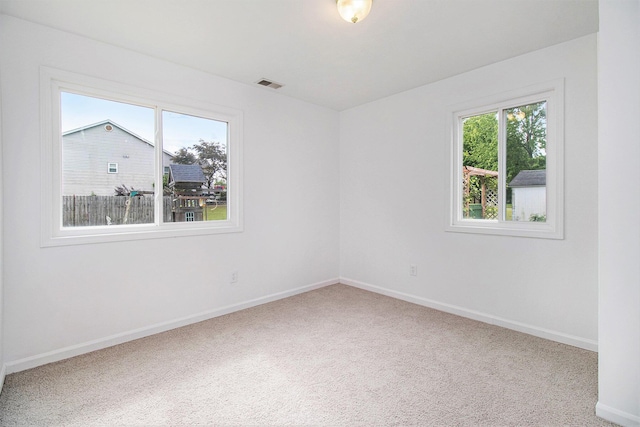 4273 20th St, Dorr, MI 49323 - empty room with healthy amount of natural light, carpet flooring, and baseboards