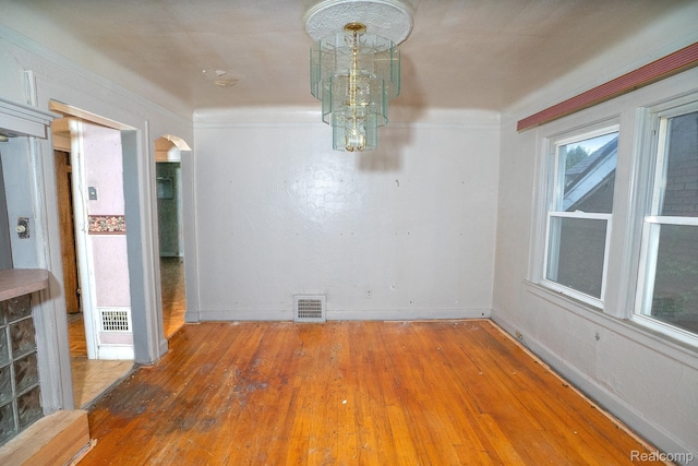 15859 Cloverlawn St, Detroit, MI 48238 - unfurnished dining area with arched walkways, hardwood / wood-style floors, and ornamental molding