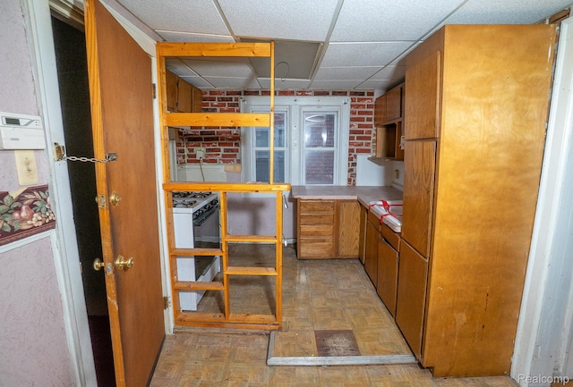 15859 Cloverlawn St, Detroit, MI 48238 - kitchen with a paneled ceiling, brown cabinets, gas range gas stove, open shelves, and light countertops