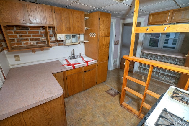 15859 Cloverlawn St, Detroit, MI 48238 - kitchen with light countertops, brown cabinets, open shelves, and a drop ceiling