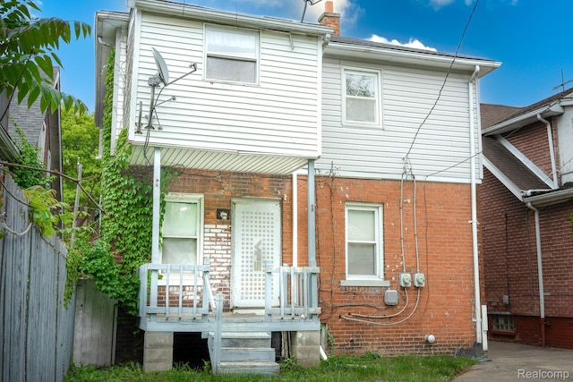 15859 Cloverlawn St, Detroit, MI 48238 - back of property with a chimney, a wooden deck, and brick siding