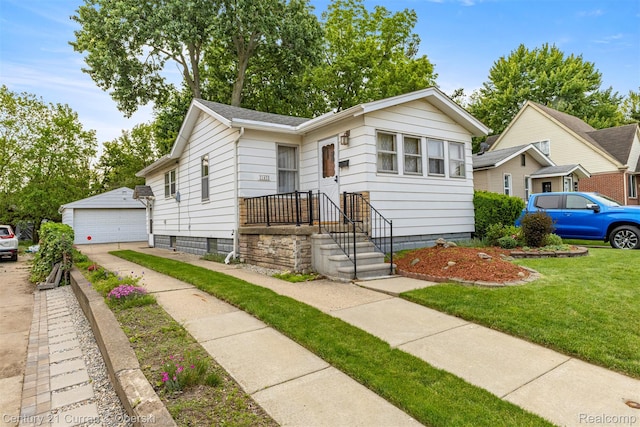 2143 Boldt St, Dearborn, MI 48124 - bungalow featuring a garage, an outdoor structure, and a front yard