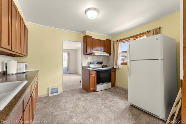 2143 Boldt St, Dearborn, MI 48124 - kitchen featuring white appliances, under cabinet range hood, healthy amount of natural light, light floors, and crown molding