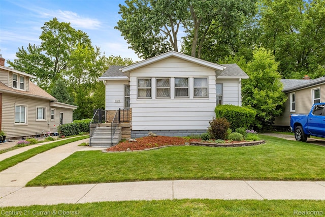 2143 Boldt St, Dearborn, MI 48124 - bungalow featuring a front yard and roof with shingles