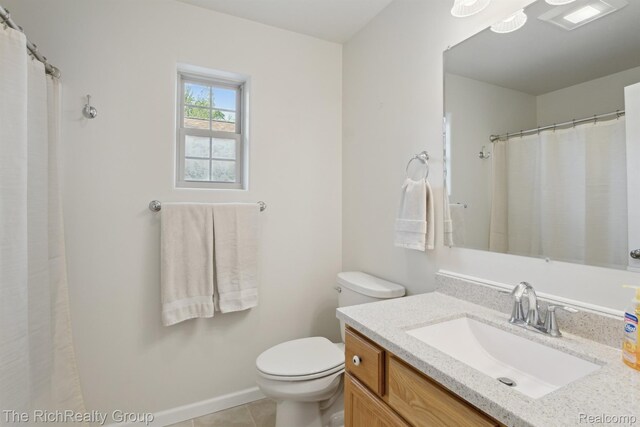 9798 Deer Track Ct, Interlochen, MI 49643 - full bath featuring toilet, vanity, tile patterned flooring, and baseboards