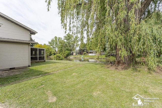 6337 Raymar St, Erie, MI 48133 - view of green lawn with a sunroom and a water view