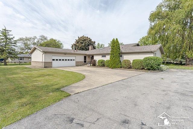 6337 Raymar St, Erie, MI 48133 - ranch-style house with driveway, an attached garage, a front yard, and a chimney