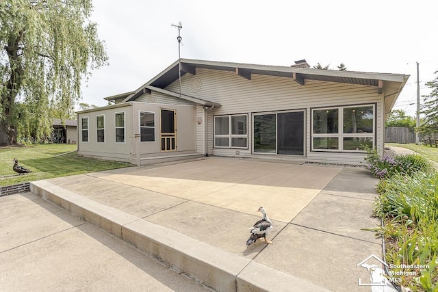 6337 Raymar St, Erie, MI 48133 - back of property with a patio area and a yard