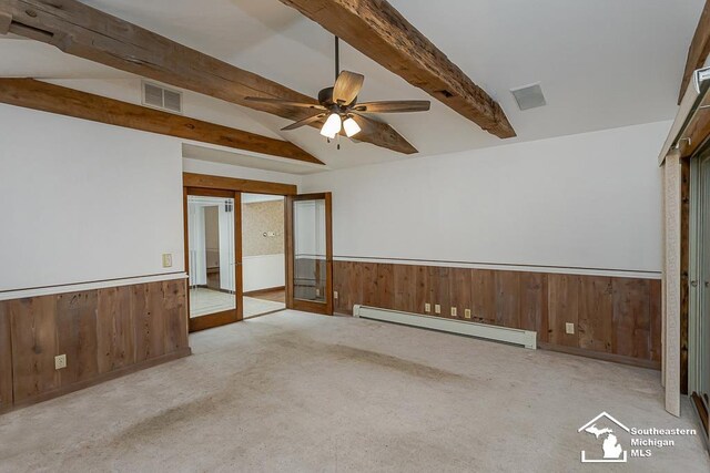 6337 Raymar St, Erie, MI 48133 - empty room with baseboard heating, wainscoting, wooden walls, a ceiling fan, and carpet