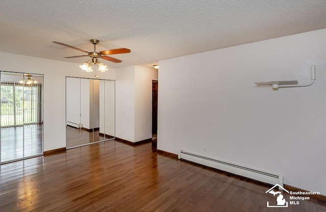 6337 Raymar St, Erie, MI 48133 - empty room featuring a baseboard heating unit, wood finished floors, ceiling fan, baseboards, and a textured ceiling