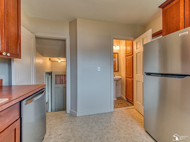 27145 James Ave, Flat Rock, MI 48134 - kitchen with appliances with stainless steel finishes and light carpet