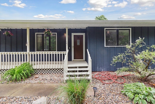 303 E Xy Ave, Vicksburg, MI 49097 - property entrance featuring board and batten siding and a porch