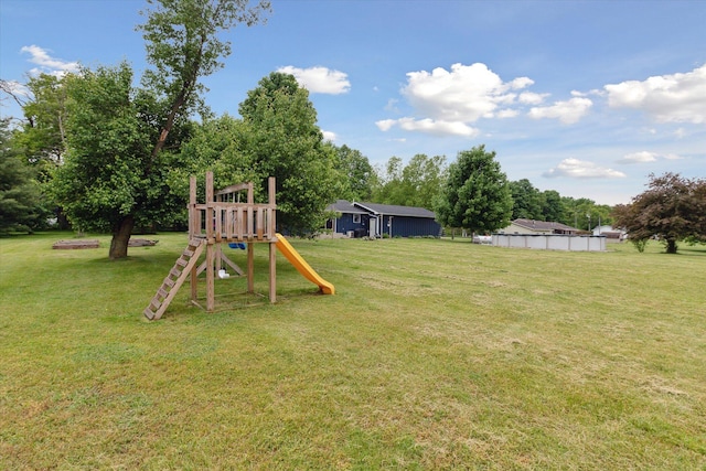 303 E Xy Ave, Vicksburg, MI 49097 - view of grassy yard featuring a playground and view of wooded area