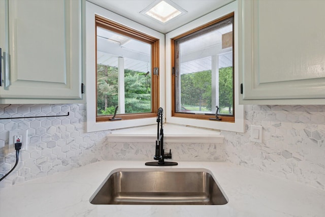 303 E Xy Ave, Vicksburg, MI 49097 - kitchen view of a sink, decorative backsplash, and light stone counters
