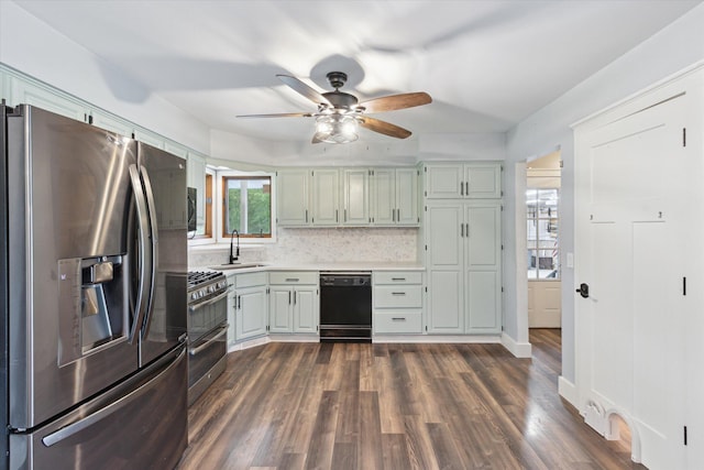 303 E Xy Ave, Vicksburg, MI 49097 - kitchen featuring stainless steel appliances, light countertops, a ceiling fan, a sink, and dark wood-style flooring