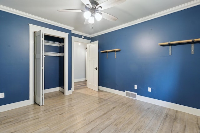 303 E Xy Ave, Vicksburg, MI 49097 - unfurnished bedroom featuring baseboards, wood finished floors, a closet, crown molding, and ceiling fan