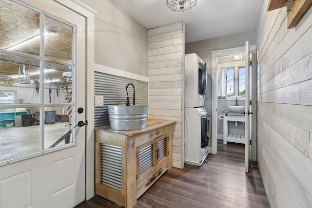 303 E Xy Ave, Vicksburg, MI 49097 - laundry area with stacked washer / dryer, wooden walls, and dark wood-style flooring