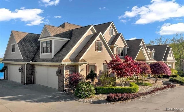 4143 Longview Dr, Lapeer, MI 48446 - view of front of property with driveway, a garage, brick siding, and a shingled roof