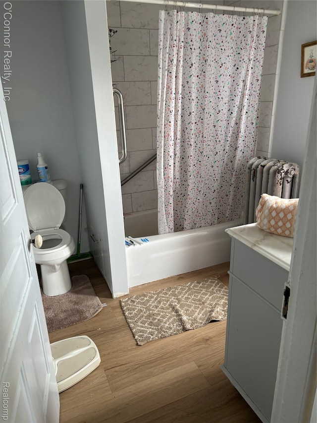 236 S Elizabeth St, Marine City, MI 48039 - full bath with toilet, radiator, vanity, shower / bath combo, and wood finished floors