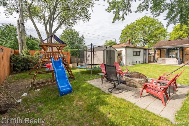 9744 Pere Ave, Livonia, MI 48150 - view of yard with an outdoor fire pit, a playground, and a patio area