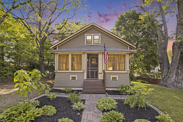 614 Denner St, Kalamazoo, MI 49006 - bungalow featuring a sunroom, entry steps, and a shingled roof