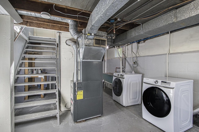 614 Denner St, Kalamazoo, MI 49006 - washroom with washer and dryer, heating unit, and concrete block wall