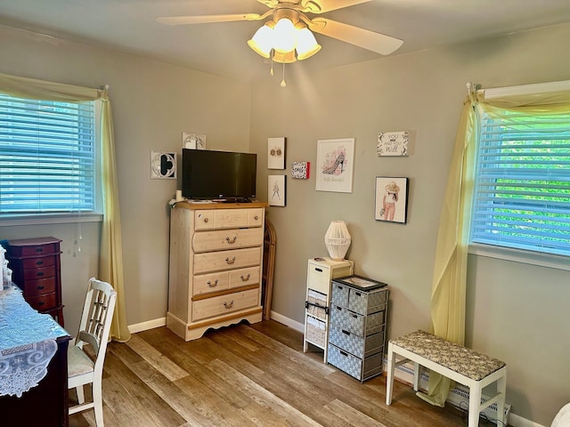 558 Terry St, Muskegon, MI 49442 - bedroom with wood finished floors, ceiling fan, and baseboards