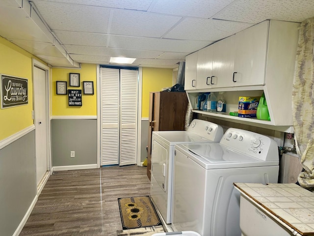 558 Terry St, Muskegon, MI 49442 - washroom featuring cabinet space, separate washer and dryer, dark wood-style flooring, wainscoting, and baseboards