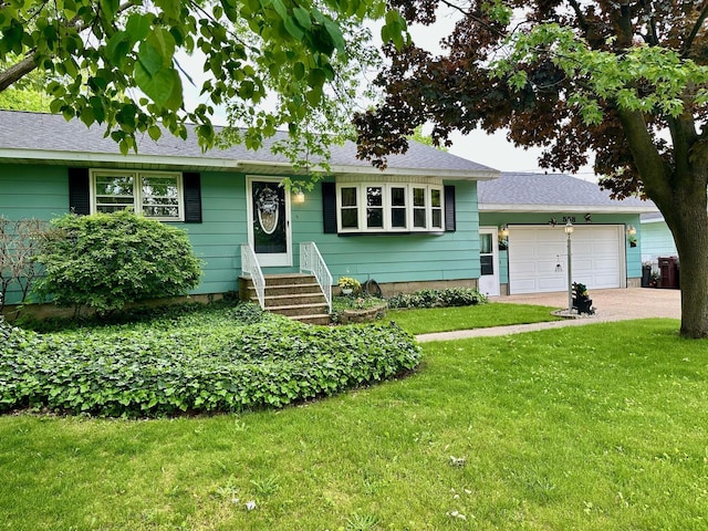 558 Terry St, Muskegon, MI 49442 - view of front of house featuring entry steps, an attached garage, a front yard, and driveway