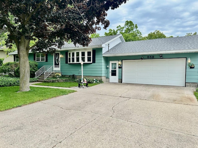 558 Terry St, Muskegon, MI 49442 - view of front of property featuring driveway, an attached garage, a front yard, and roof with shingles
