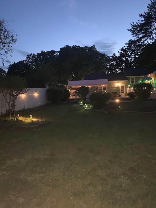 558 Terry St, Muskegon, MI 49442 - yard at dusk with a carport