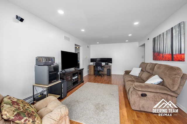 2203 Porter St SW Unit 104, Wyoming, MI 49519 - living area featuring wood finished floors, recessed lighting, a desk, and baseboard heating