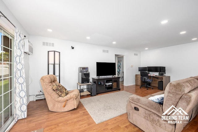 2203 Porter St SW Unit 104, Wyoming, MI 49519 - living room with wood finished floors, recessed lighting, a desk, and a wall mounted air conditioner