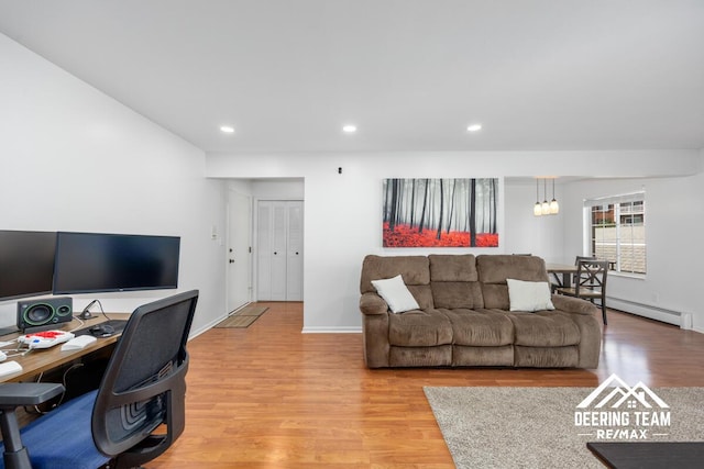 2203 Porter St SW Unit 104, Wyoming, MI 49519 - living area featuring light wood finished floors, recessed lighting, a desk, baseboard heating, and baseboards
