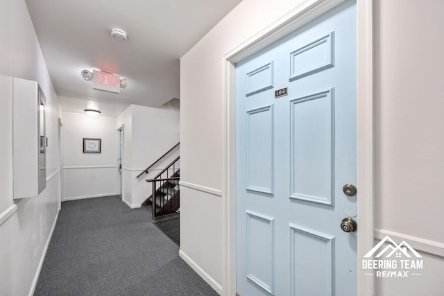 2203 Porter St SW Unit 104, Wyoming, MI 49519 - hallway with an upstairs landing, baseboards, and dark carpet
