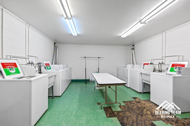 2203 Porter St SW Unit 104, Wyoming, MI 49519 - communal laundry room featuring washer and dryer, tile patterned floors, and concrete block wall
