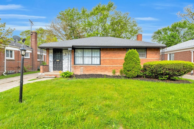 20241 Braile St, Detroit, MI 48219 - view of front facade with a chimney, brick siding, and a front yard