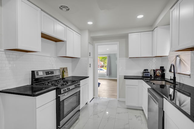 20241 Braile St, Detroit, MI 48219 - kitchen with stainless steel appliances, a sink, light marble finish flooring, recessed lighting, and white cabinetry