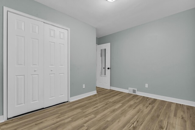 20241 Braile St, Detroit, MI 48219 - unfurnished bedroom with baseboards, light wood finished floors, and a closet