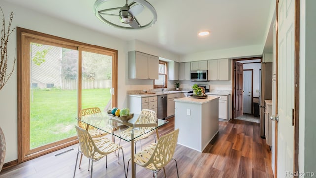 1755 Country View Dr, Okemos, MI 48864 - kitchen with appliances with stainless steel finishes, light countertops, a center island, dark wood-style floors, and recessed lighting