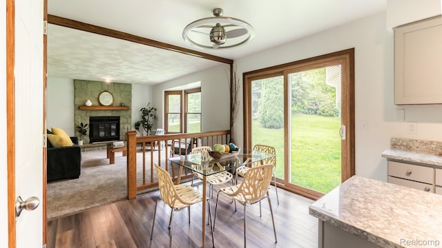 1755 Country View Dr, Okemos, MI 48864 - dining space featuring wood finished floors, a fireplace, and beamed ceiling