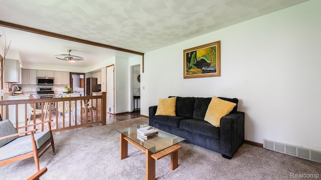 1755 Country View Dr, Okemos, MI 48864 - living area with carpet, a ceiling fan, and baseboards