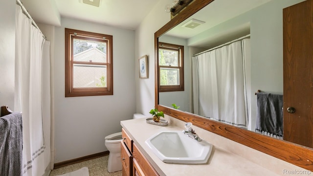 1755 Country View Dr, Okemos, MI 48864 - full bathroom featuring toilet, vanity, baseboards, and curtained shower