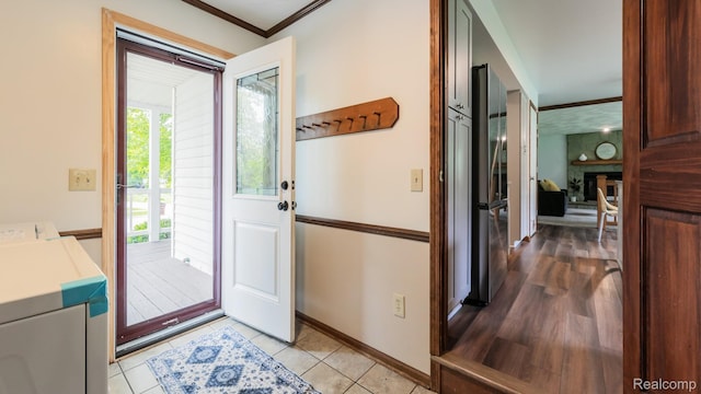 1755 Country View Dr, Okemos, MI 48864 - entryway featuring crown molding, separate washer and dryer, baseboards, and light tile patterned flooring